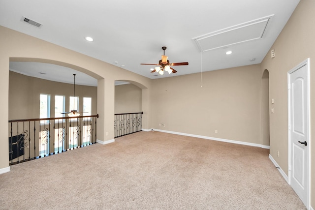 empty room with ceiling fan and light carpet