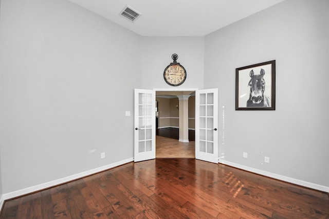 spare room with french doors and wood-type flooring