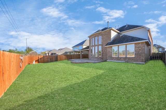 rear view of property with a lawn and a patio area