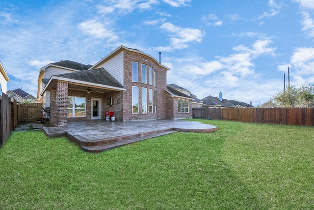 rear view of house featuring a patio and a lawn