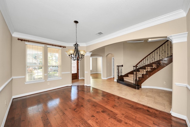 unfurnished dining area with an inviting chandelier, wood-type flooring, and ornamental molding