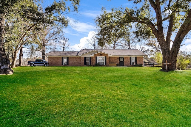 ranch-style home with a front lawn