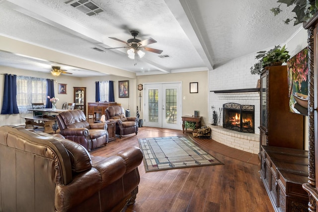 living room with beamed ceiling, french doors, a textured ceiling, and dark hardwood / wood-style floors