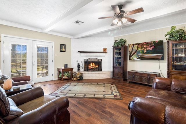 living room with beam ceiling, a textured ceiling, french doors, and dark wood-type flooring