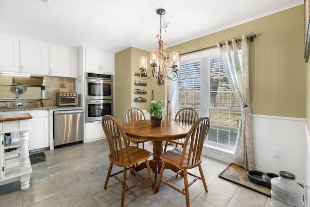 tiled dining room with plenty of natural light, a textured ceiling, and a chandelier