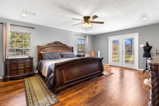 bedroom featuring ceiling fan, access to exterior, french doors, and multiple windows