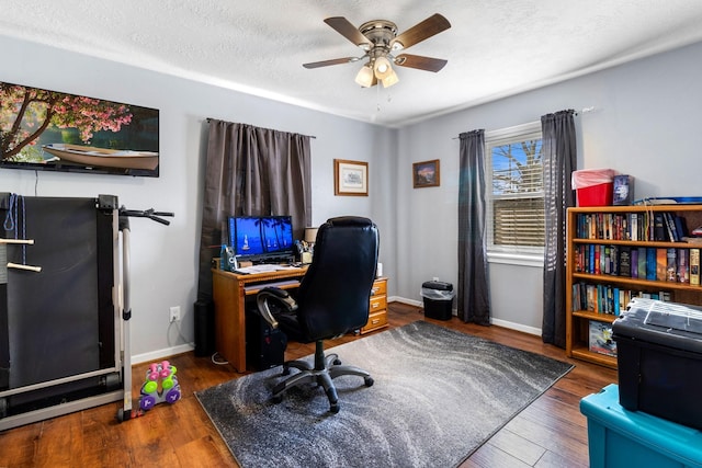 office space with ceiling fan, dark hardwood / wood-style flooring, and a textured ceiling