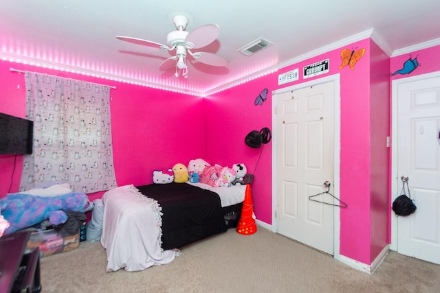 bedroom with ceiling fan, ornamental molding, and carpet floors