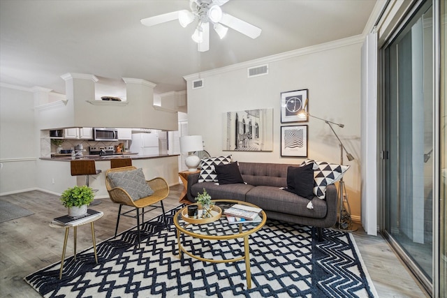 living room with ceiling fan, light hardwood / wood-style floors, and ornamental molding