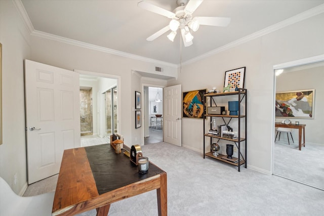 carpeted home office with ceiling fan and ornamental molding