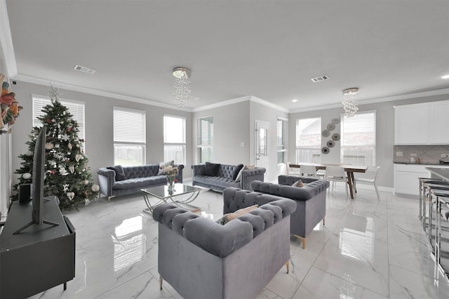 living room featuring a notable chandelier and ornamental molding