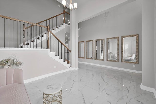 entrance foyer featuring a towering ceiling and an inviting chandelier