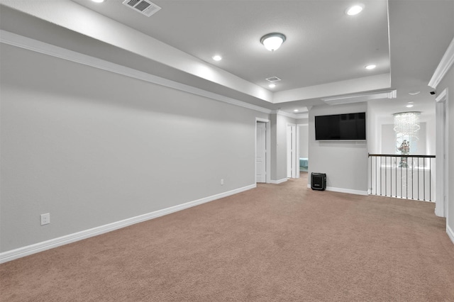 interior space with a tray ceiling and crown molding