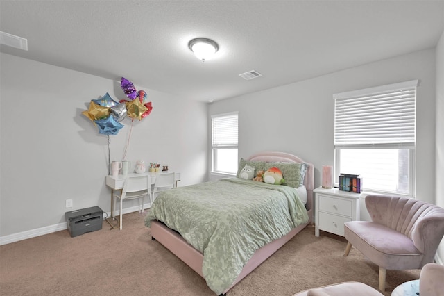 carpeted bedroom featuring a textured ceiling