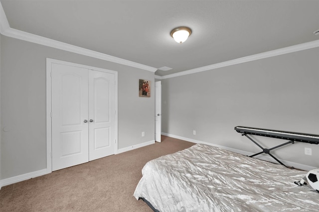 carpeted bedroom with a closet and crown molding