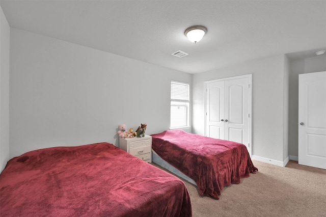 carpeted bedroom featuring a closet