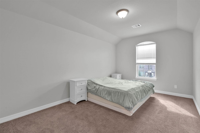 bedroom with lofted ceiling and carpet floors