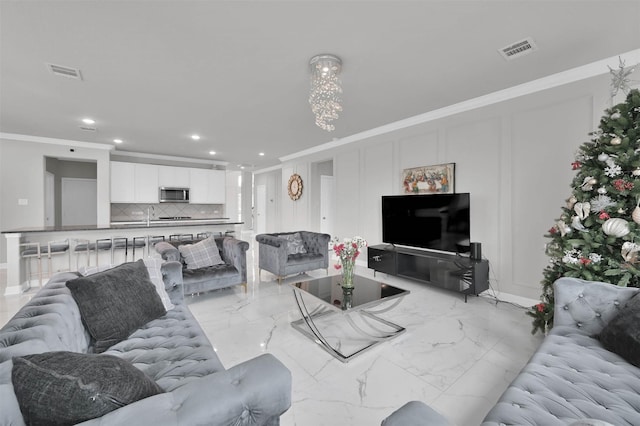 living room featuring crown molding and sink