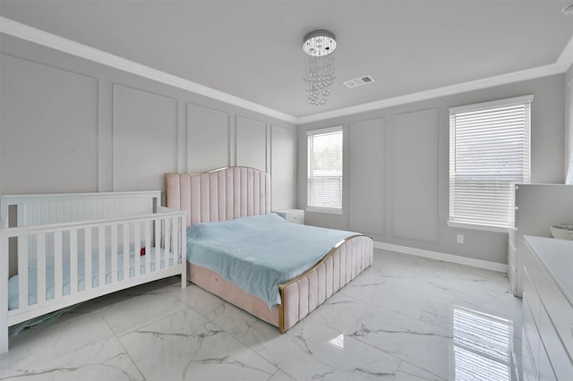 bedroom with ornamental molding and a notable chandelier