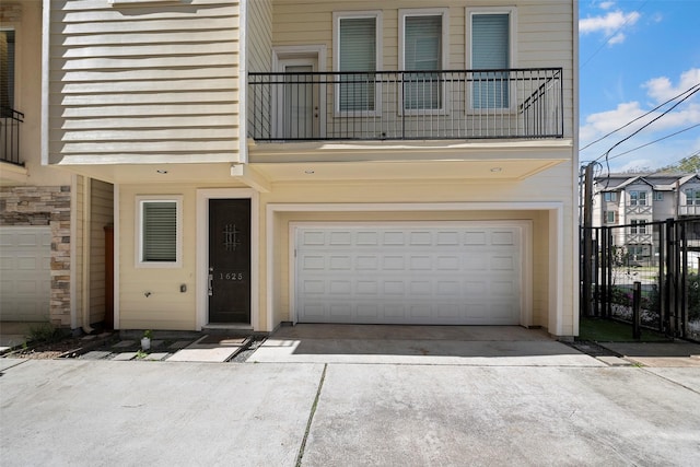 view of front facade with a balcony and a garage