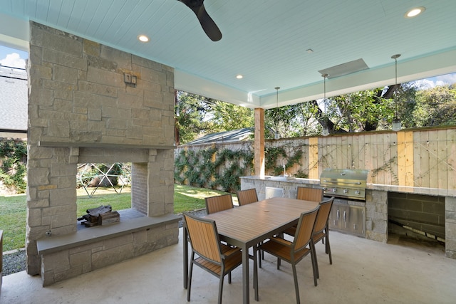 view of patio with ceiling fan, area for grilling, and grilling area