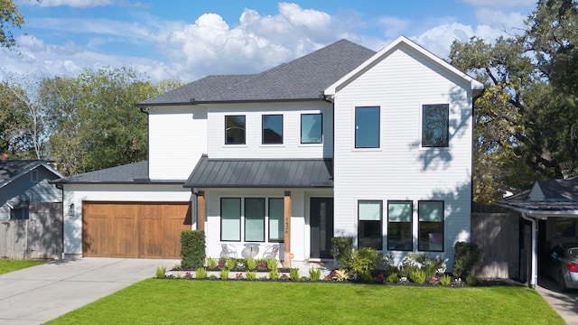 view of front facade featuring a porch, a front lawn, and a garage