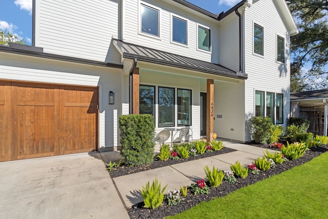 view of front of home featuring a garage and a porch