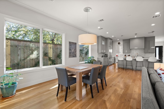 dining room featuring light hardwood / wood-style floors and sink