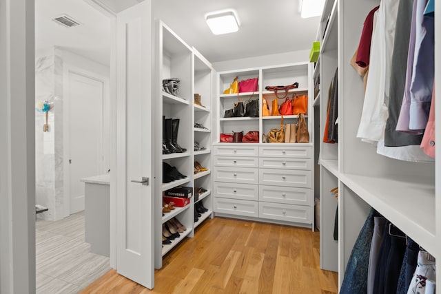 walk in closet featuring light hardwood / wood-style floors