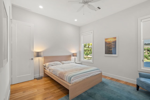 bedroom with ceiling fan and light hardwood / wood-style floors