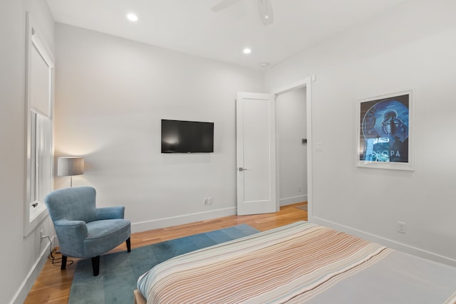 bedroom with ceiling fan and hardwood / wood-style flooring