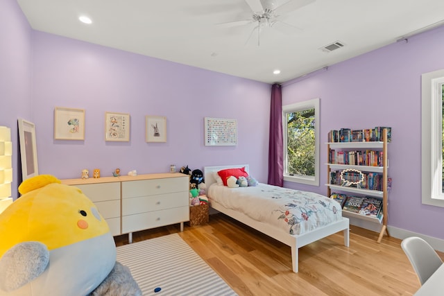 bedroom with ceiling fan and light hardwood / wood-style flooring