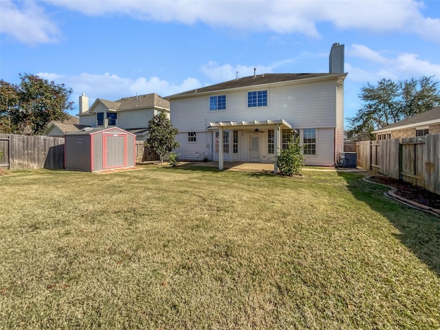 back of house with a patio, a storage unit, a lawn, and central AC