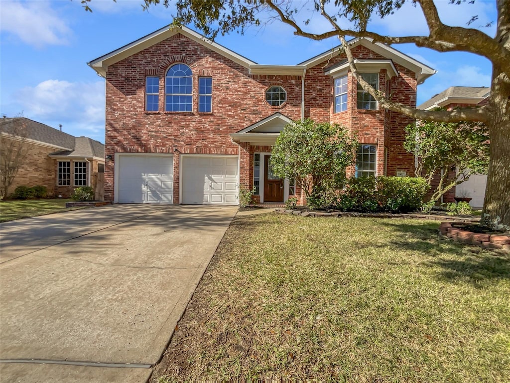 view of front property featuring a front lawn and a garage