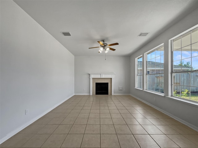 unfurnished living room with ceiling fan and light tile patterned floors