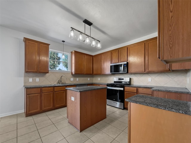 kitchen featuring pendant lighting, a center island, stainless steel appliances, light tile patterned floors, and sink