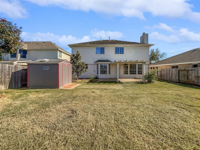 rear view of property with a patio area, a yard, and a shed