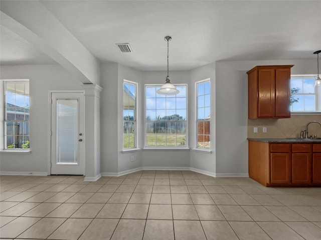 unfurnished dining area featuring light tile patterned floors and sink