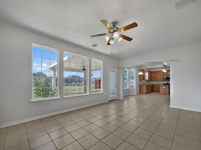 unfurnished living room featuring ceiling fan and light tile patterned flooring