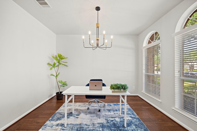 office space featuring dark hardwood / wood-style floors and an inviting chandelier