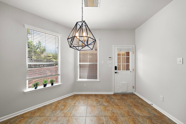 unfurnished dining area with an inviting chandelier