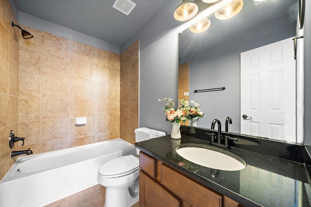 full bathroom featuring vanity, toilet, and tiled shower / bath