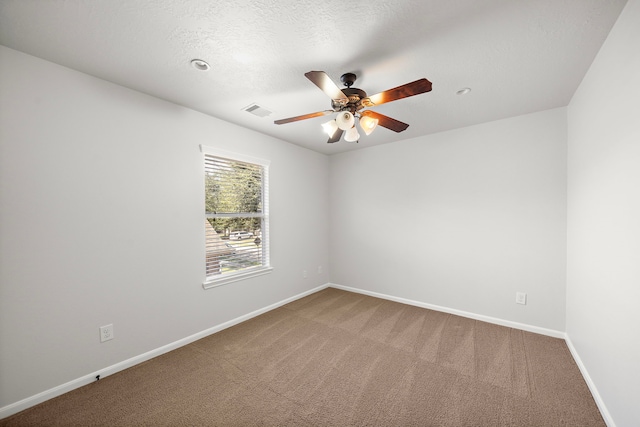 carpeted spare room featuring a textured ceiling