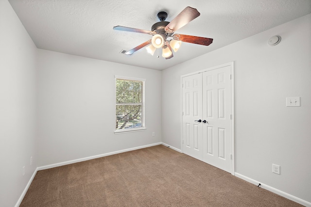 interior space with ceiling fan and a textured ceiling