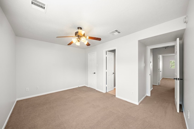 unfurnished bedroom featuring ceiling fan and light colored carpet