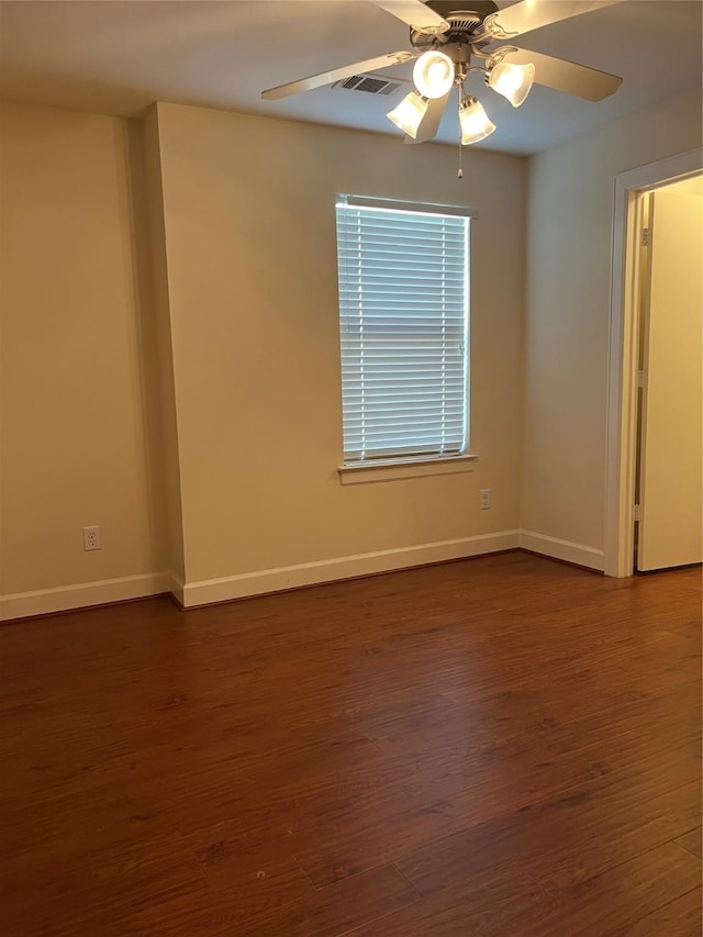 unfurnished room with ceiling fan and dark wood-type flooring