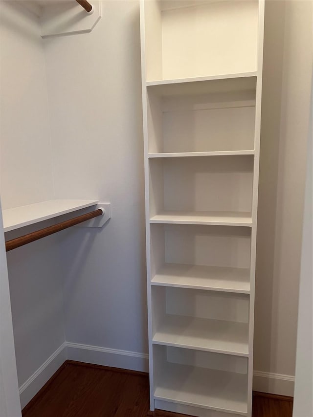 walk in closet featuring dark wood-type flooring