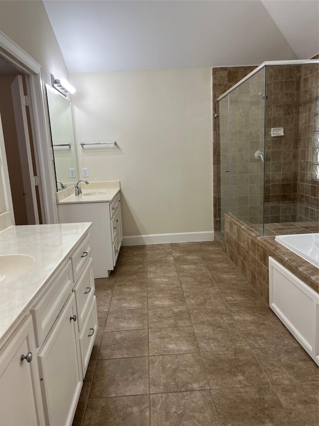 bathroom featuring vanity, lofted ceiling, and shower with separate bathtub