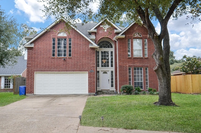 view of front property featuring a front lawn and a garage