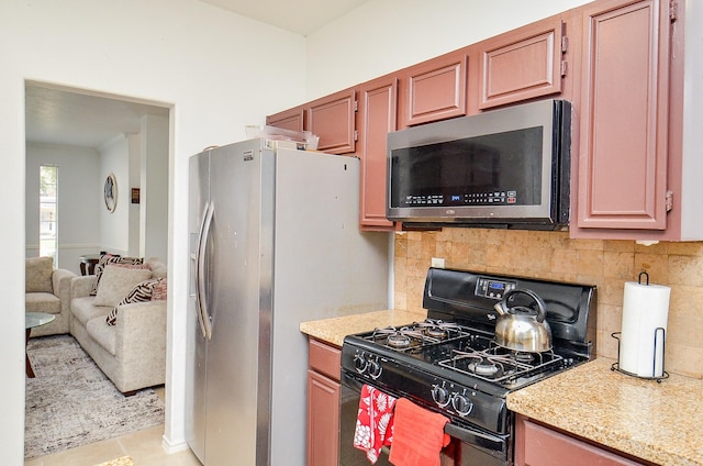 kitchen with decorative backsplash, light tile patterned floors, and stainless steel appliances